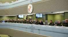 Putin sitting with his military council
